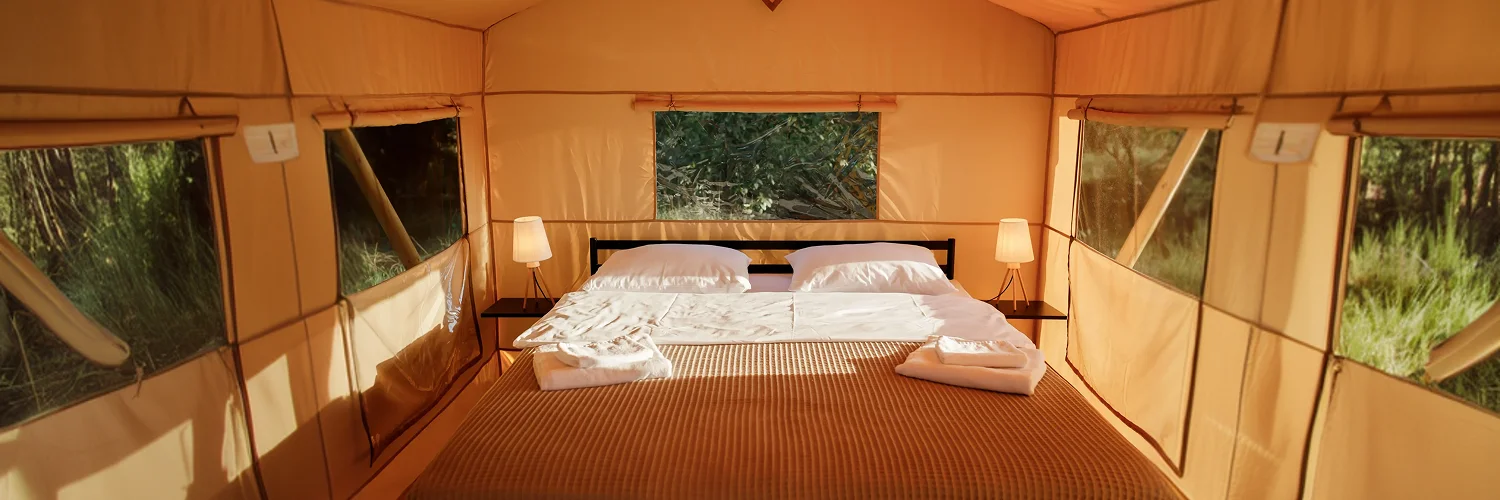 interior-cozy-open-glamping-tent-with-light-inside-sunset-luxury-camping-tent-outdoor-summer-holiday-vacation-lifestyle-concept (1) 2.webp